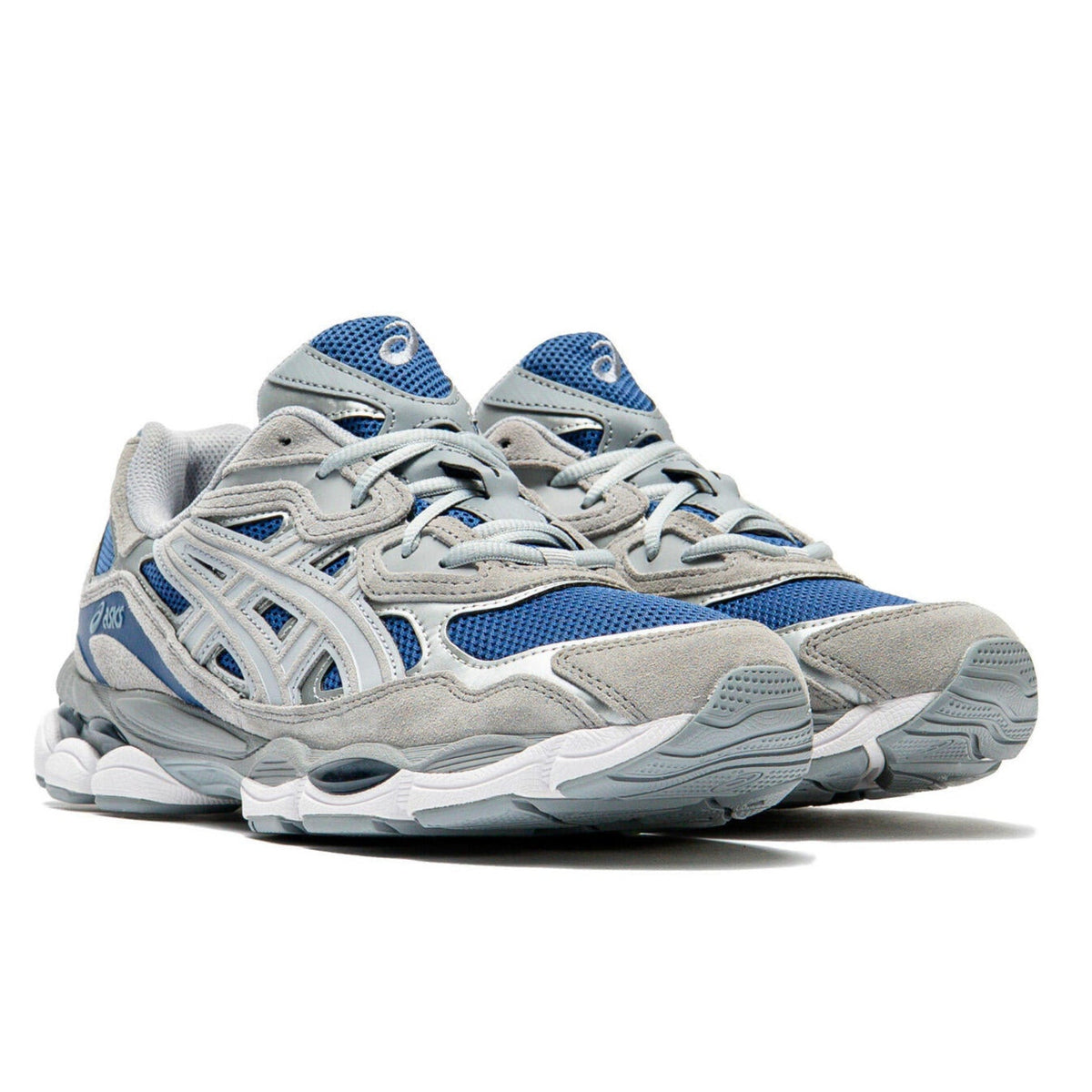 A pair of ASICS GEL-NYC Twilight Blue Gravel trainers featuring deep blue mesh, soft grey overlays, signature ASICS stripes and a sculpted cushioned sole on a clean white background.