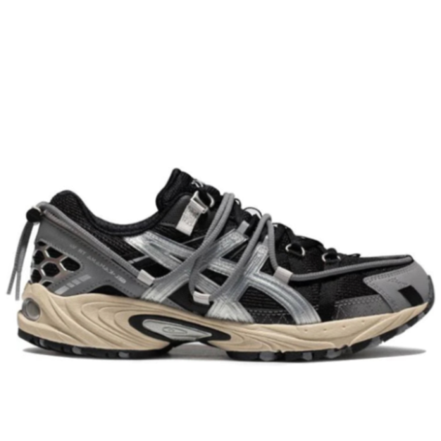 Side profile of the ASICS Kahana TR V2 Black Silver (1203A259-001), highlighting the rugged urban utility design, aggressive silver Tiger Stripes, and chunky midsole.