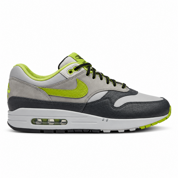 A side view of the HUF x Nike Air Max 1 Grey Green showing the smooth grey leather upper, perforated detailing and signature green leather Swoosh.