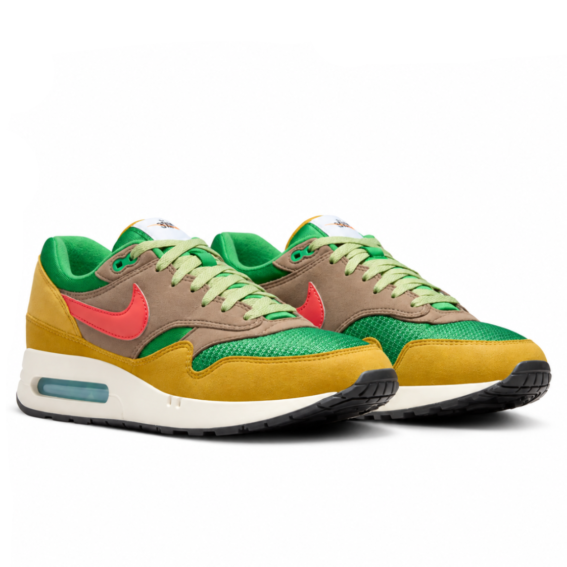 A pair of Nike Air Max 1 ’86 PRM Powerwall BRS trainers featuring green mesh, brown suede overlays, glossy orange Nike Swooshes and Big Bubble Air cushioning on a clean white background.
