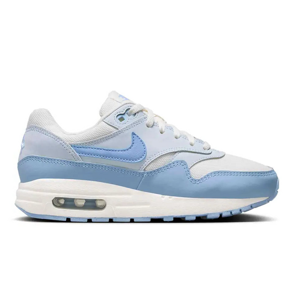 A side view of the Nike Air Max 1 GS Sail Blue Tint trainer, showing the Sail mesh upper, soft blue mudguard, matching Nike Swoosh and classic visible Air midsole.