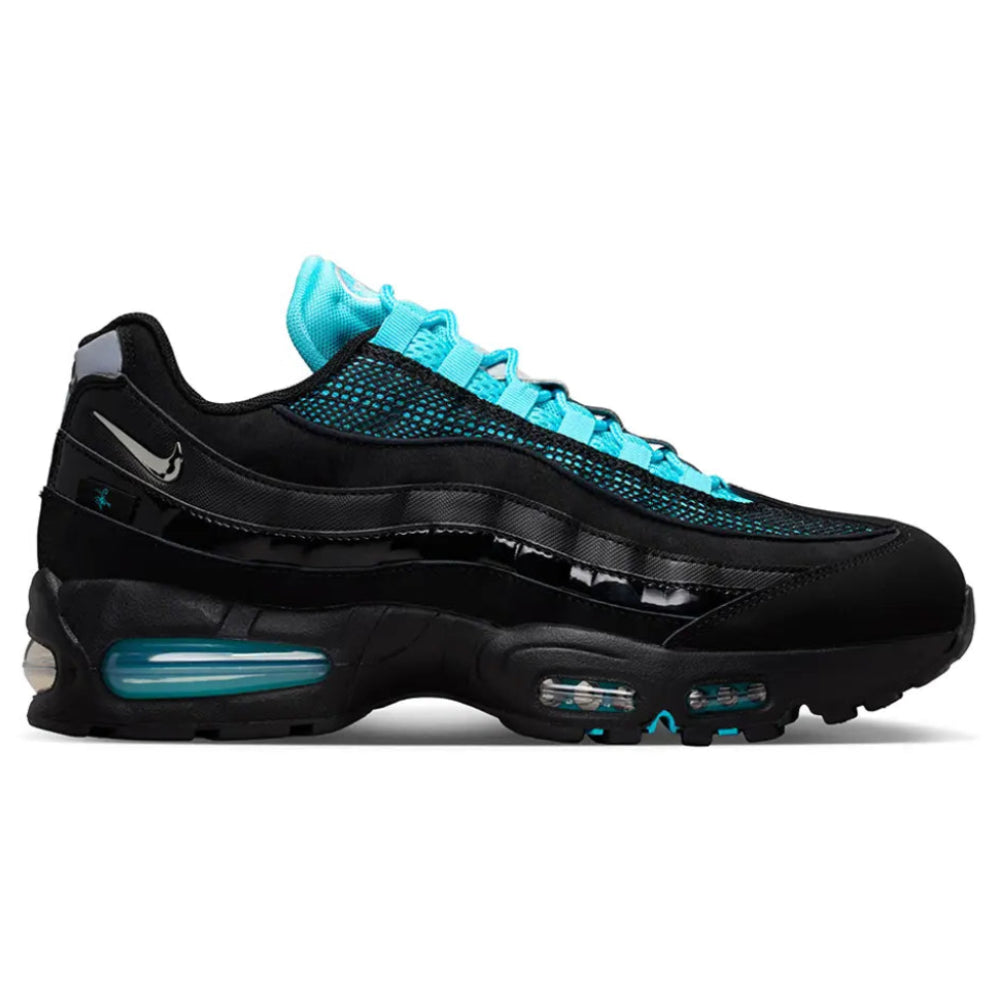 A side view of the Nike Air Max 95 Big Bubble SE Scorpion trainer, showing the black wavy panels, metallic detailing, scorpion graphic and enlarged visible Air units.