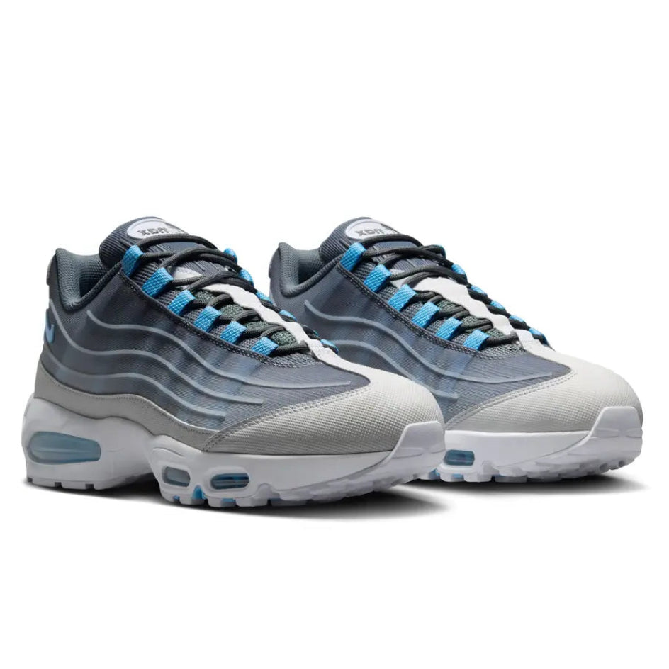 A pair of Nike Air Max 95 Smoke Grey trainers featuring layered grey and white panels, Football Blue accents, breathable mesh and visible Nike Air cushioning on a clean white background.