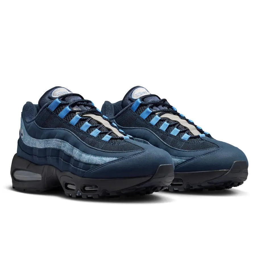 A pair of Nike Air Max 95 Big Bubble SE Multi Obsidian Work Blue White trainers featuring layered blue and navy panels, breathable mesh, signature Nike Swoosh detailing and visible Air cushioning on a clean white background.