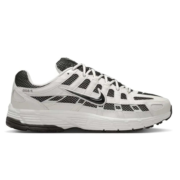 A side view of the Nike P-6000 Sail Off Noir trainer, showing the Sail upper, layered grey detailing, Nike Swoosh and lightweight foam midsole.