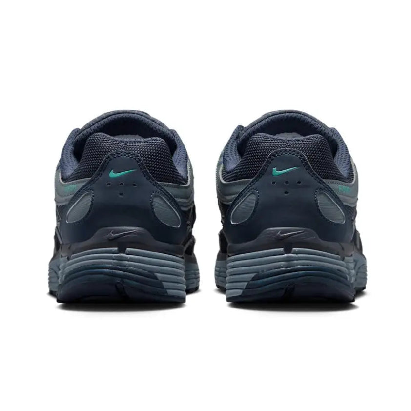 A rear view of the Nike P-6000 Winterised Thunder Eclipse trainers, showing the structured layered heel, dark blue colour palette and reflective detailing.