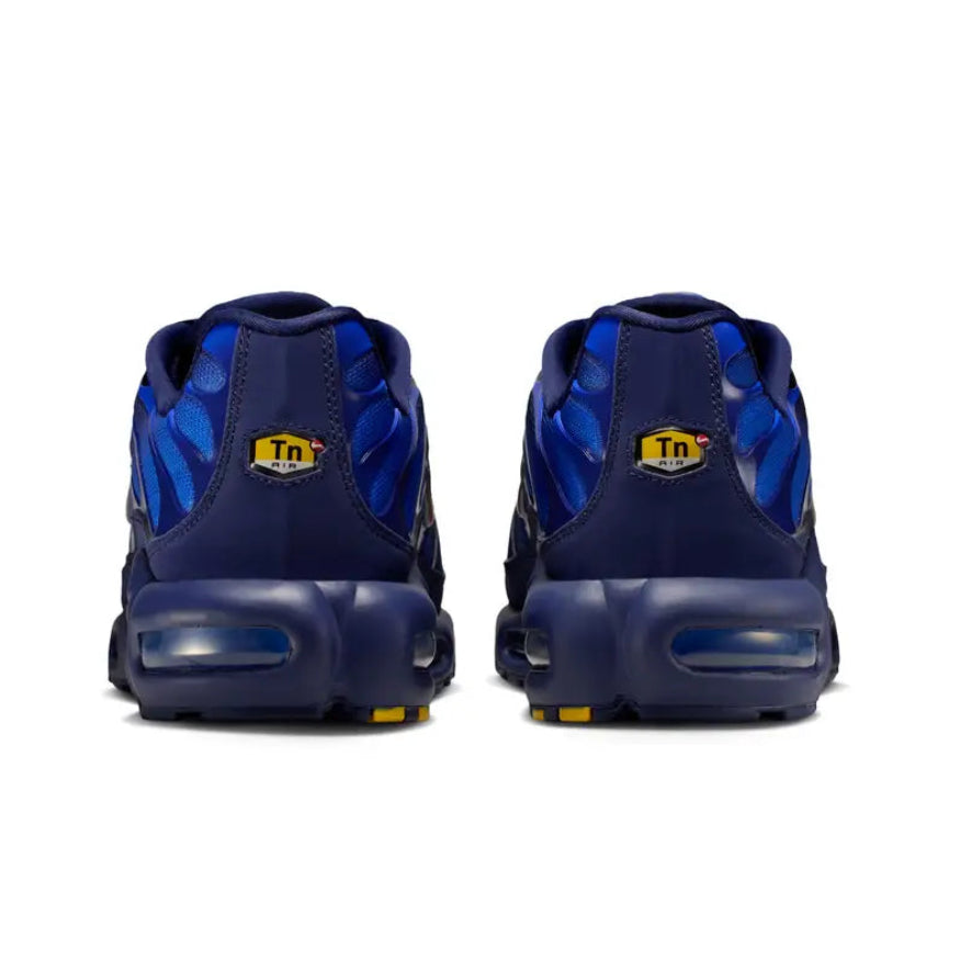 A rear view of the Nike Air Max Plus TN French Football Federation trainers, showing the structured heel, blue tonal detailing, TN branding and visible Air cushioning on a clean white background.