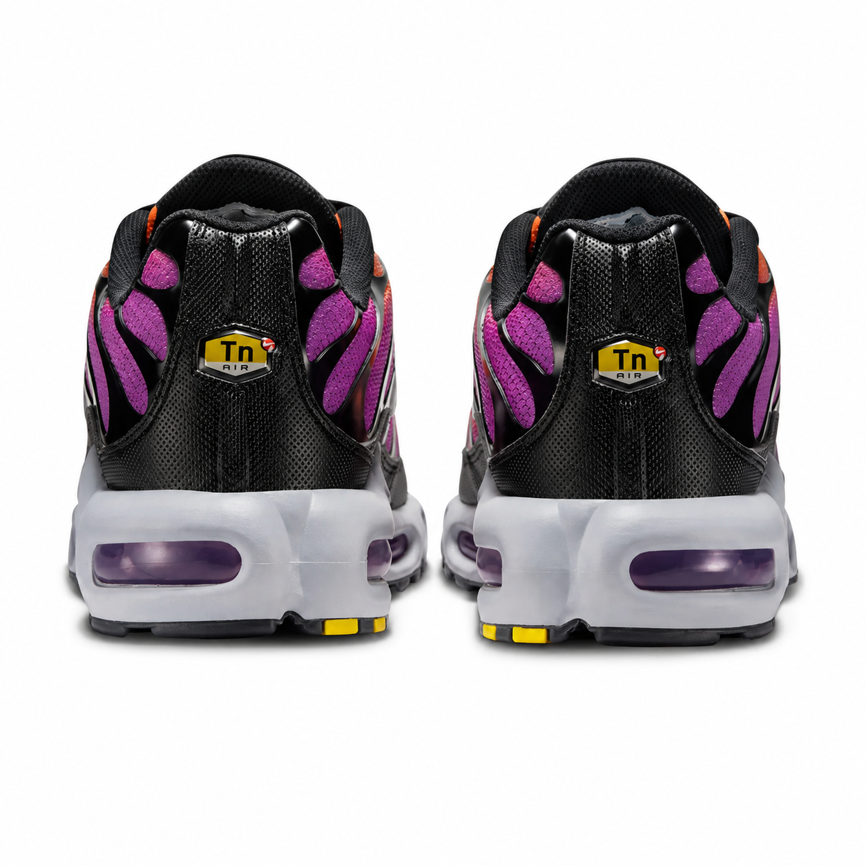 A rear view of the Nike Air Max Plus TN Desert Sunset trainers, showing the black heel construction, purple mesh accents, yellow TN Air branding, grey midsole and visible purple Air cushioning on a clean white background.