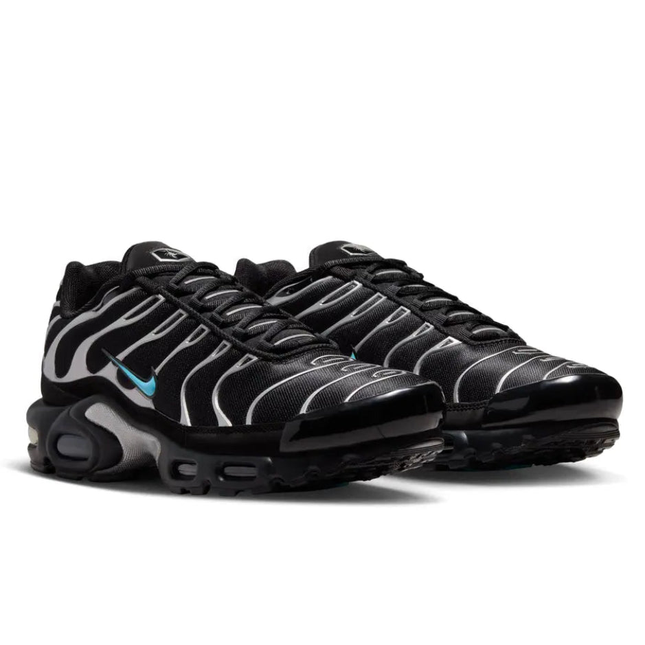 A pair of Nike Air Max Plus VII Scorpion Black trainers featuring an all-black textile upper, synthetic overlays, scorpion detailing and visible Air cushioning on a clean white background.