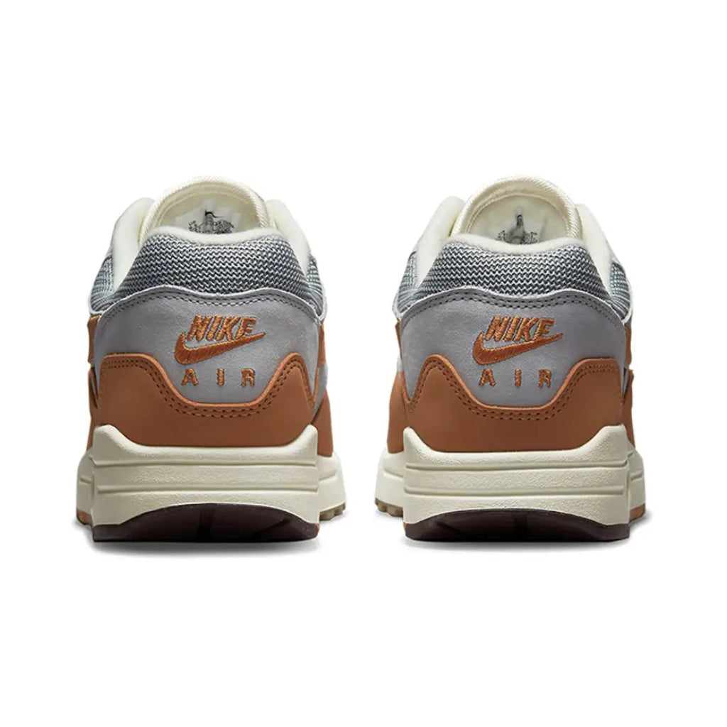 A rear view of the Patta x Nike Air Max 1 Monarch showing the orange heel detailing, co-branded finish and Sail midsole.